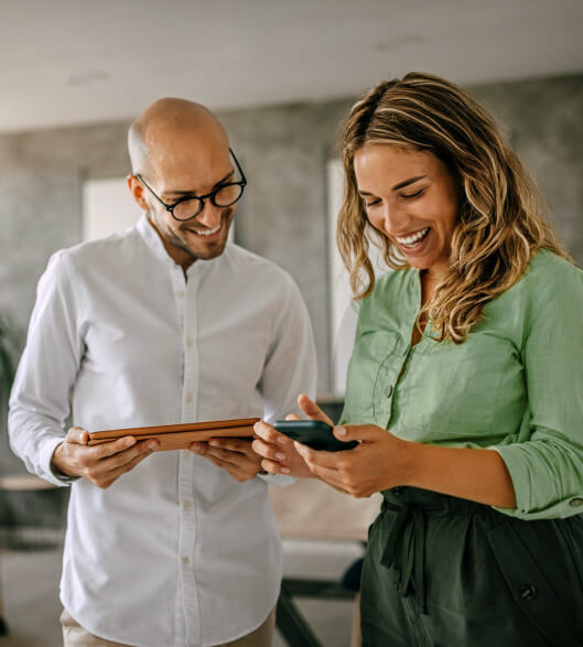 A man and a woman looking at a phone